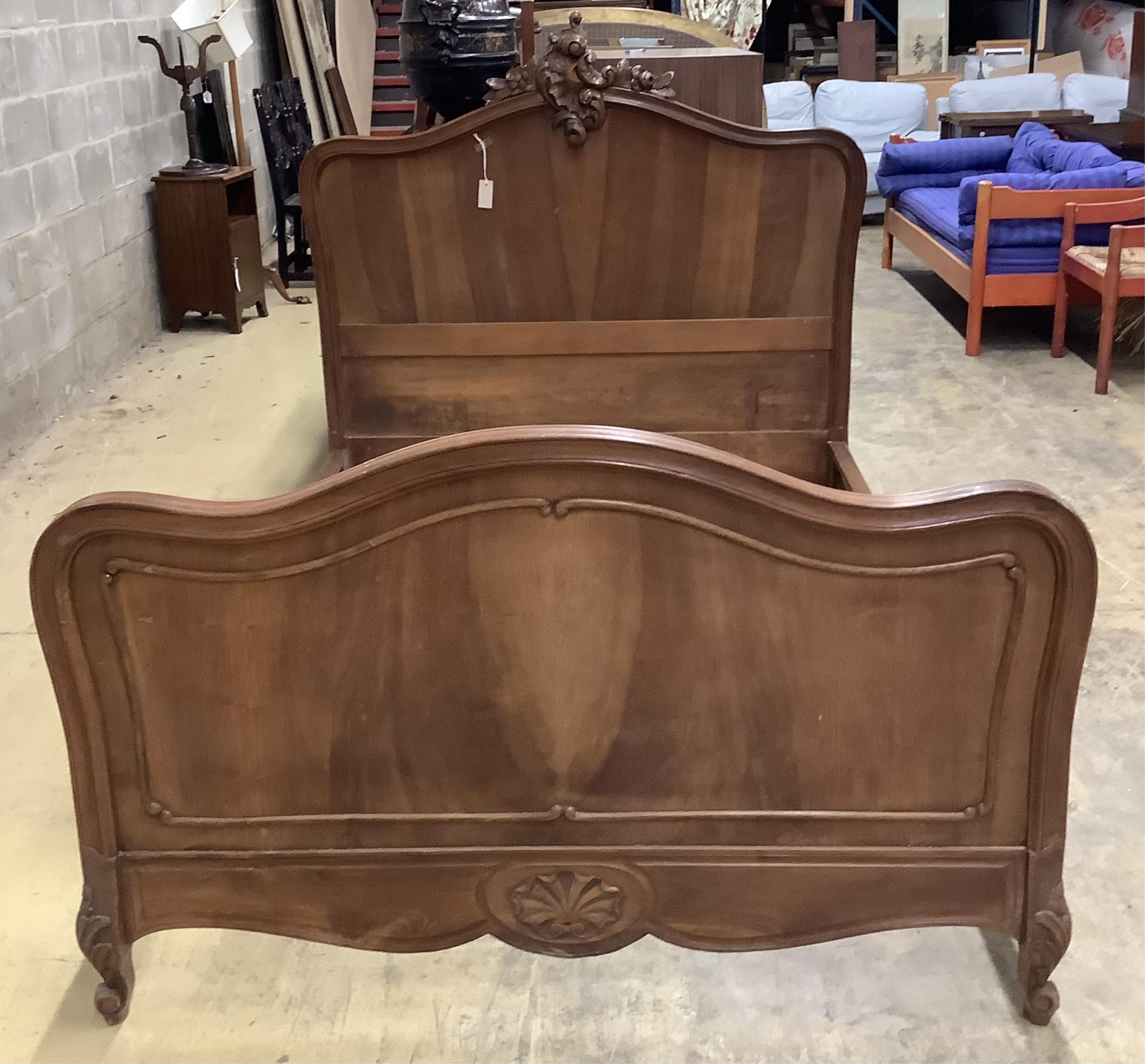 An early 20th century French walnut bedframe, width 140cm, length 199cm, height 142cm. Condition - fair